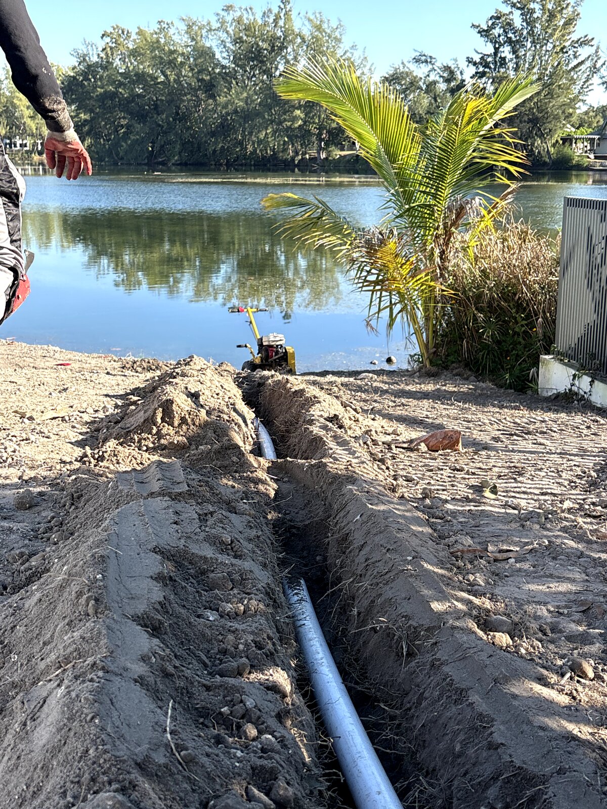 irrigation pipe trenching near Miami lake