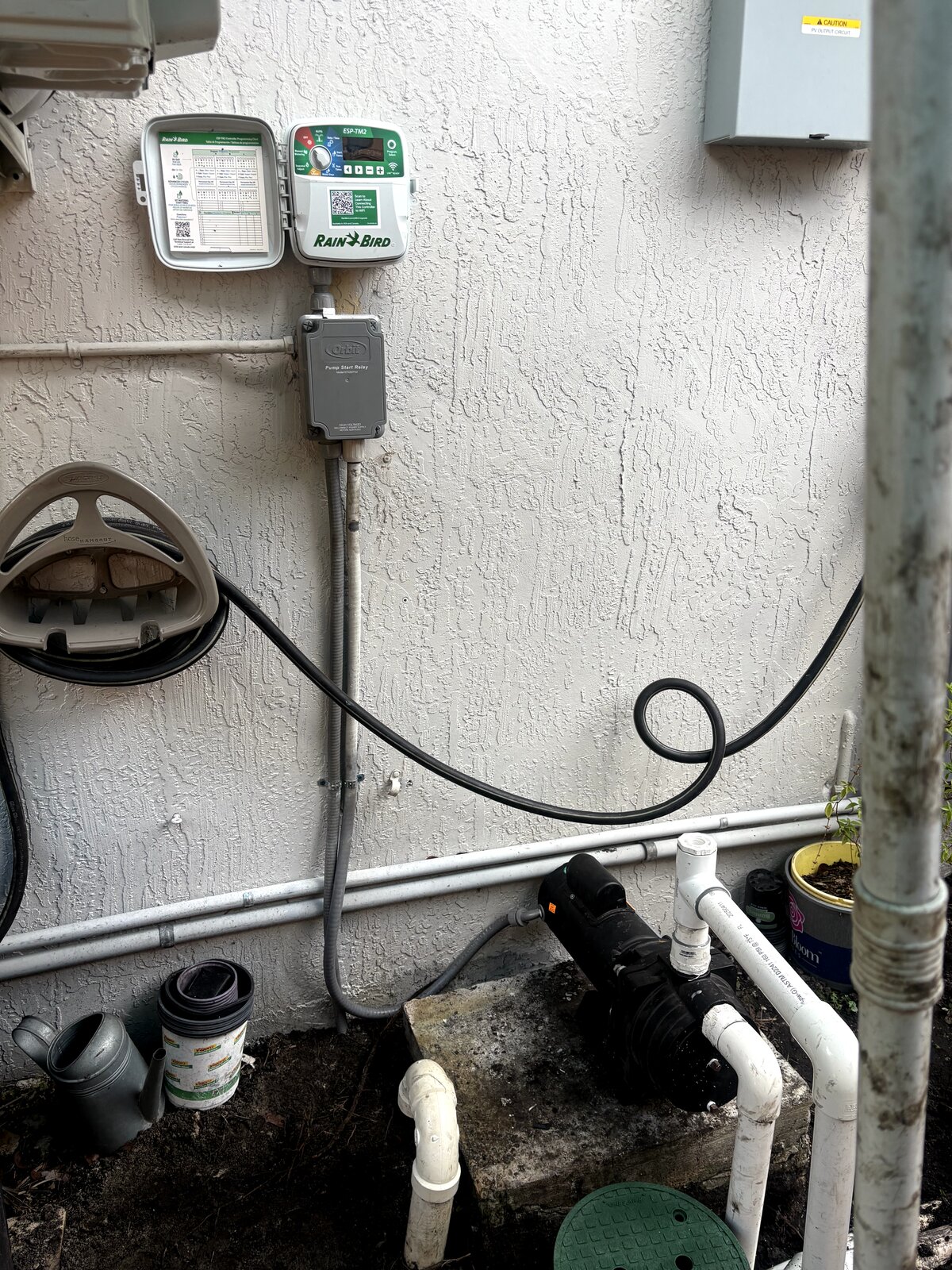 Rain Bird controller and pump relay installed alongside 1800 series spray heads in Miami