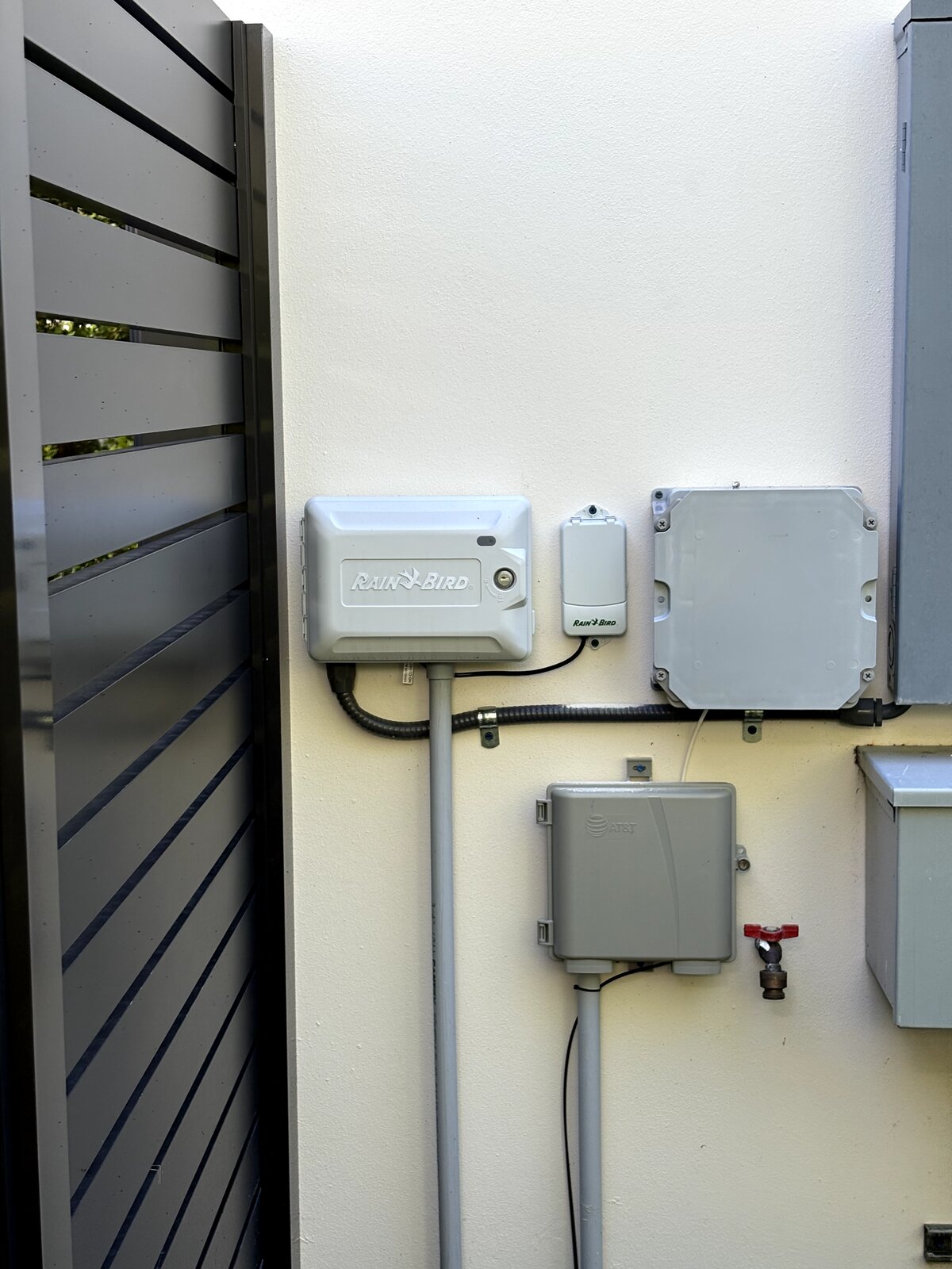 Rain Bird ESP-Me smart WiFi controller installed with rain sensor in a Miami home